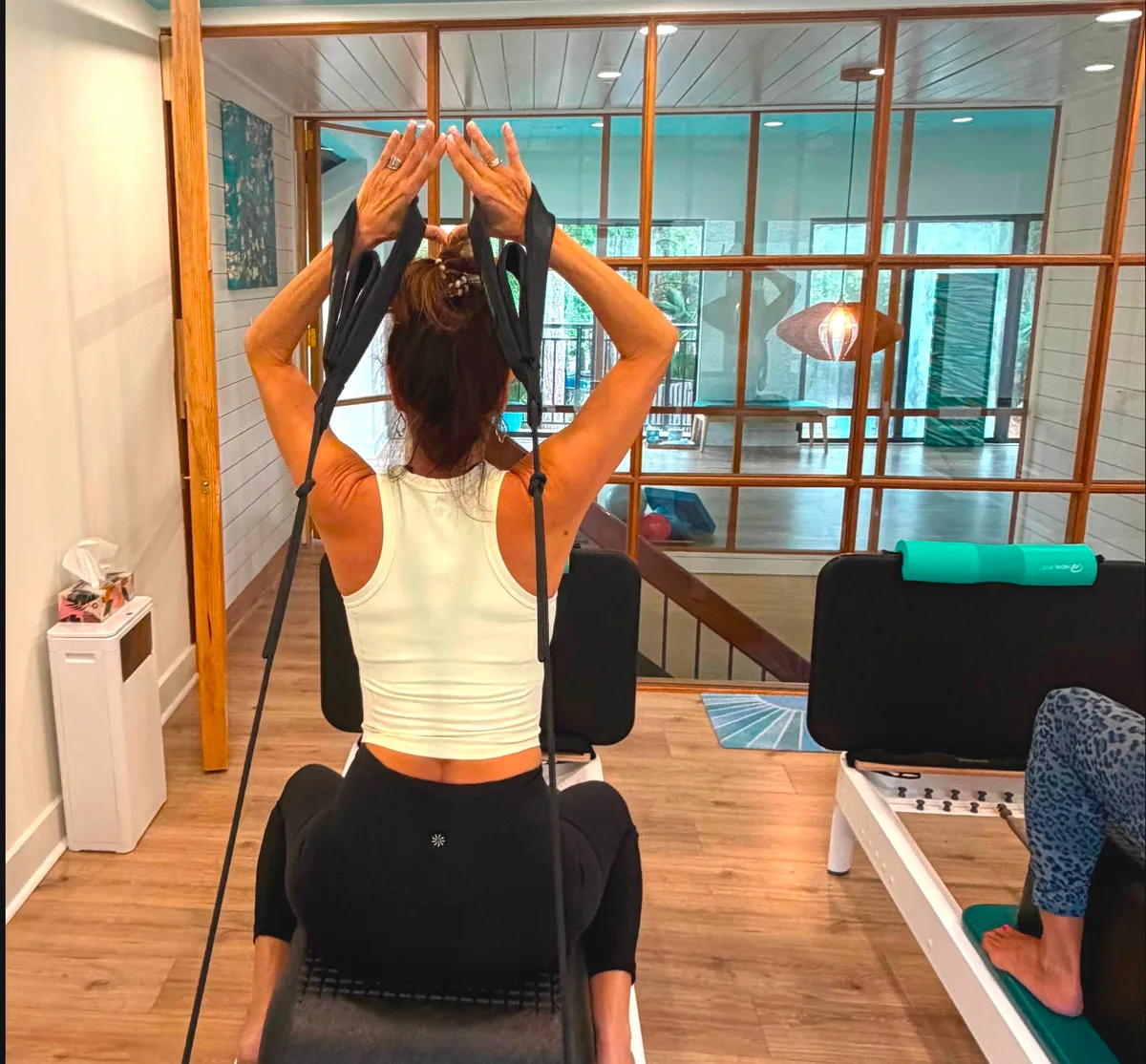 A client working on the reformer in the Blue Sky Pilates studio