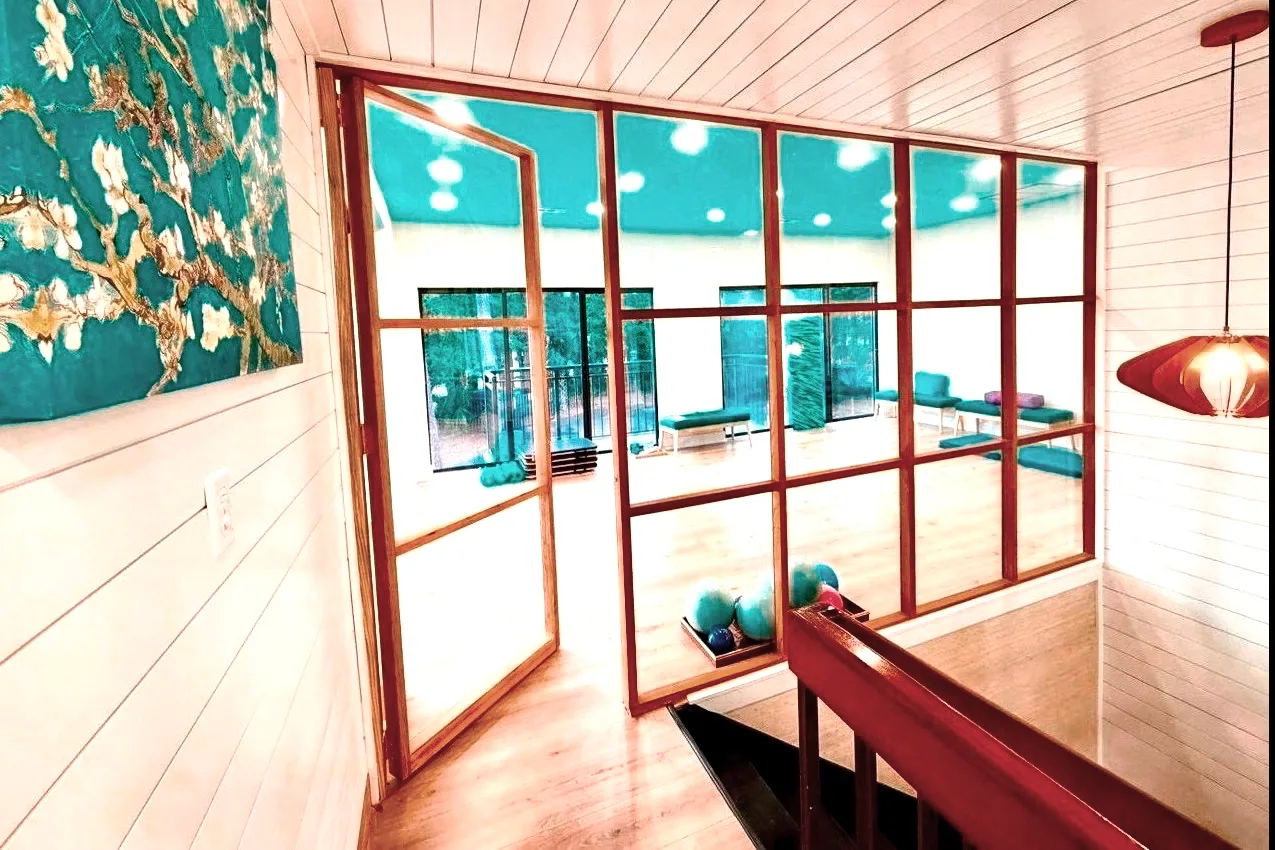 The bright, airy Blue Sky Pilates yoga room seen through the studio's glass doors
